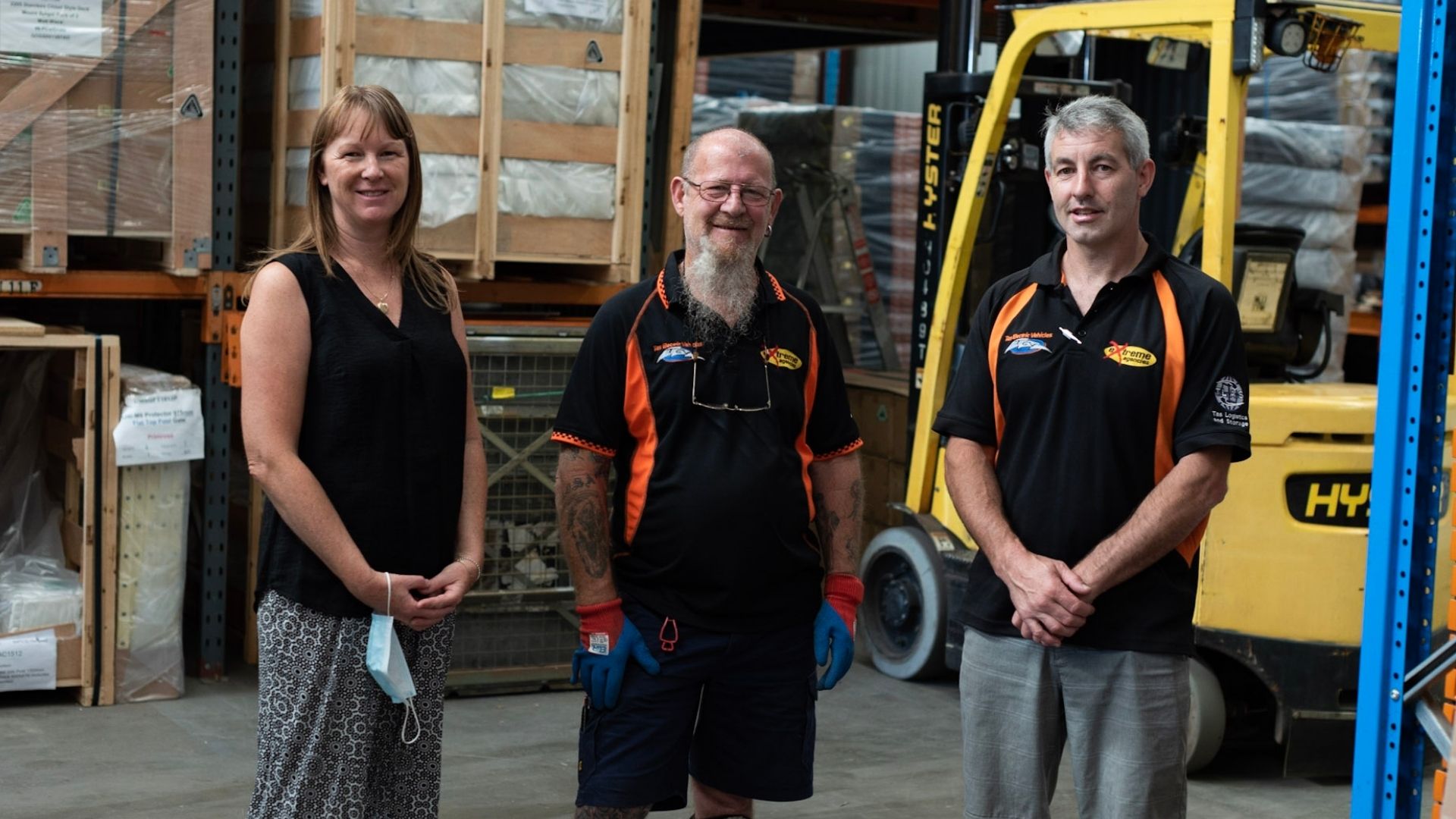 Charles is standing in his Extreme Agencies unifrm next to employment consultant, Jodie, and employer.