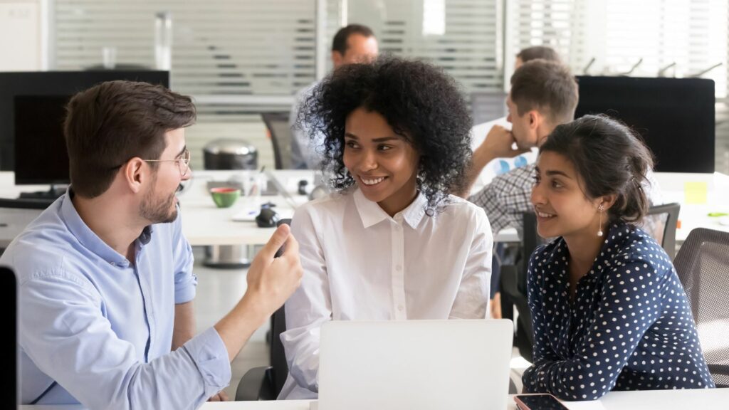 Group of smiling young professionals in a discussion.
