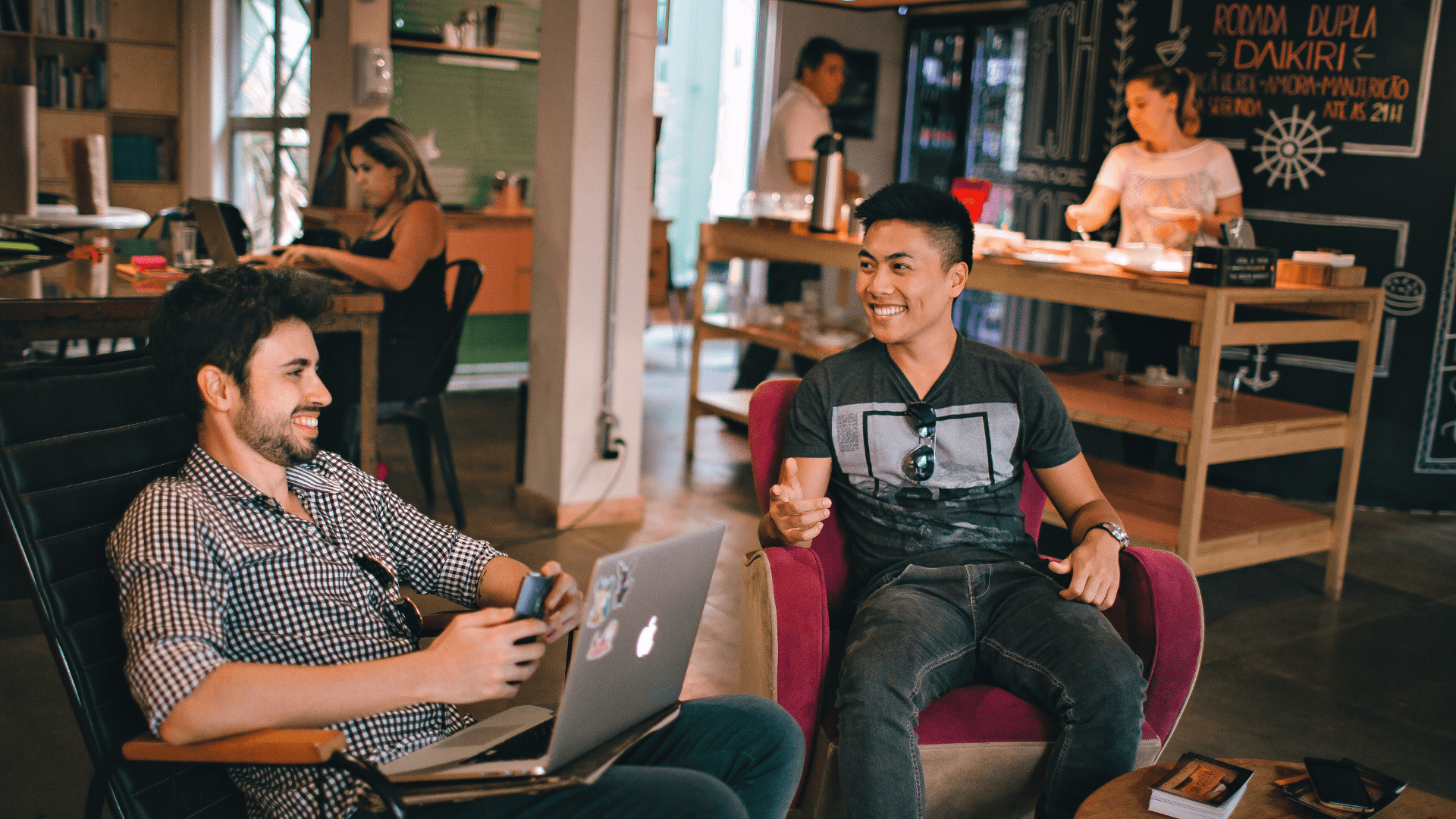 Two young men chatting at an office.