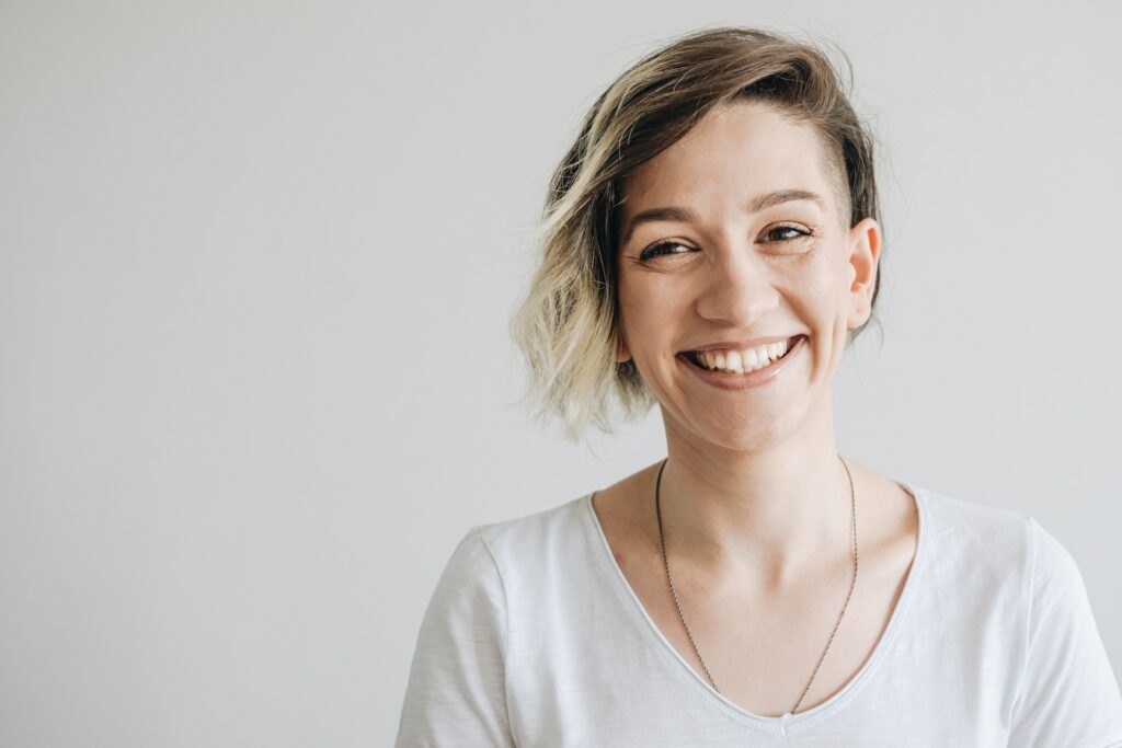 Beautiful young girl with short hair smiling.