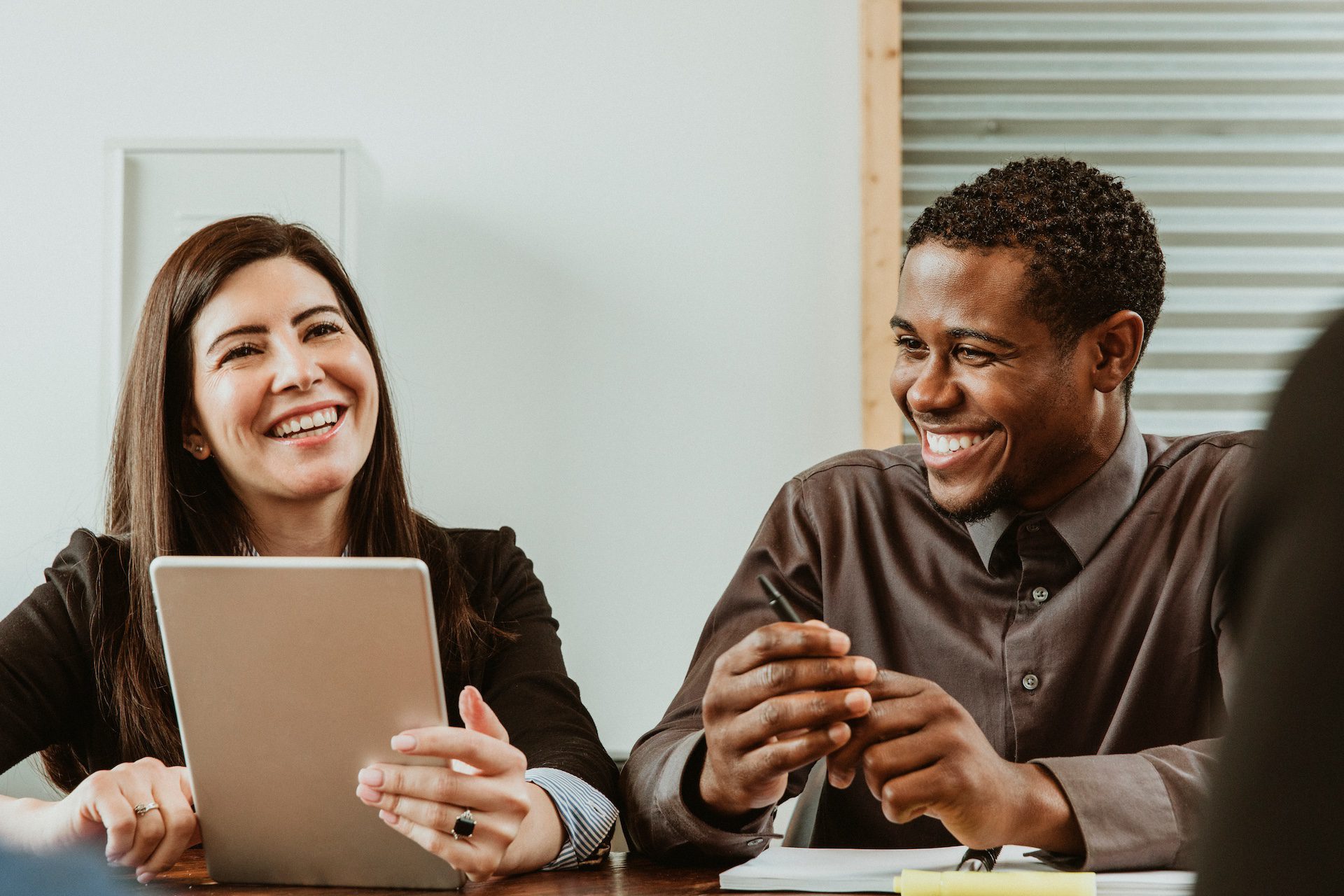 Happy businesspeople working in a meeting room.