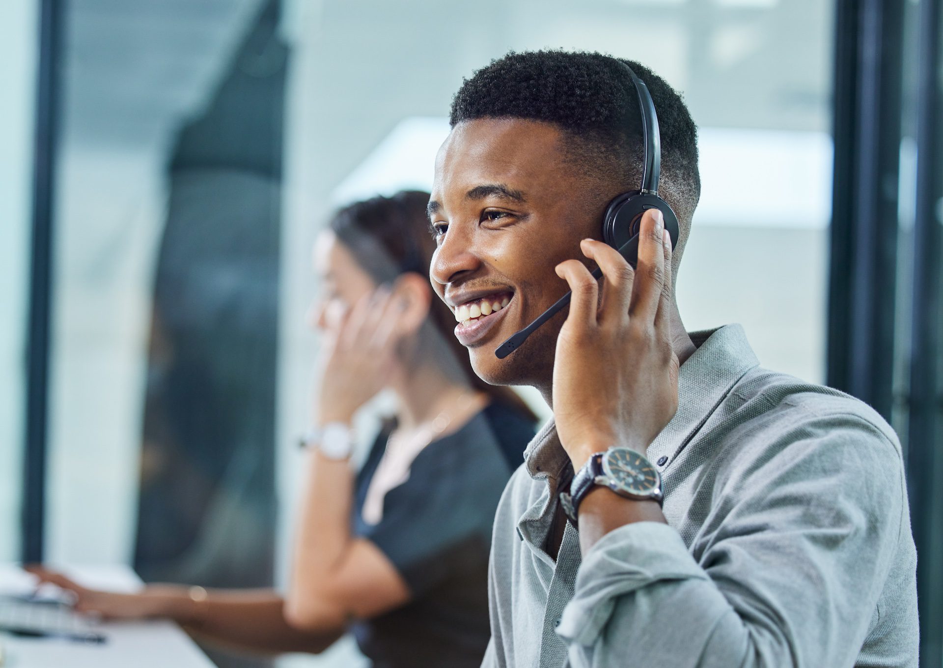 Shot of a young call center agent on a call in an office, ready to assist customers.
