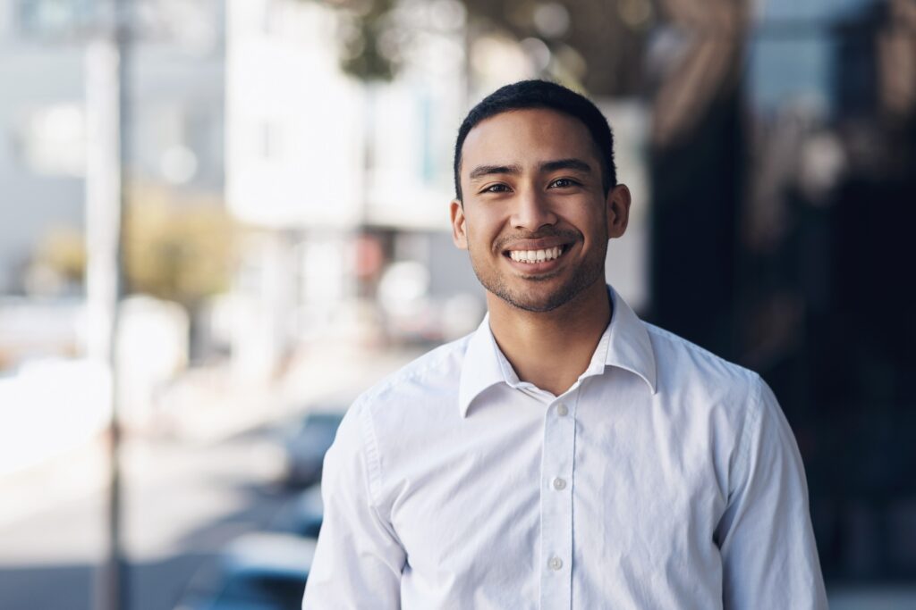 Happy portrait of a businessman in the city, exuding confidence and positivity, representing a successful entrepreneur.