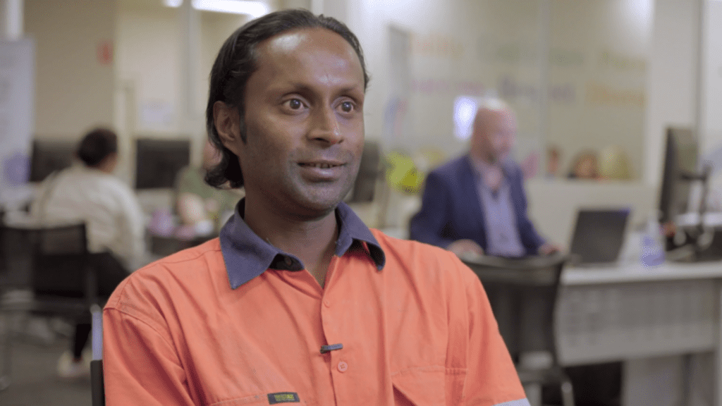 Atash wearing a work shirt in office setting