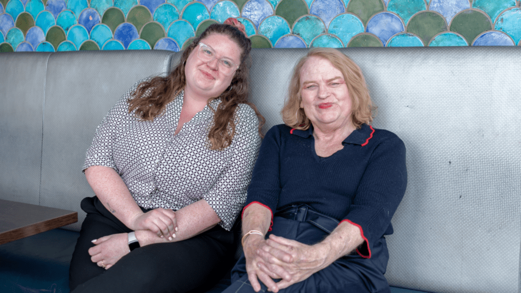 Two women smiling at the camera.