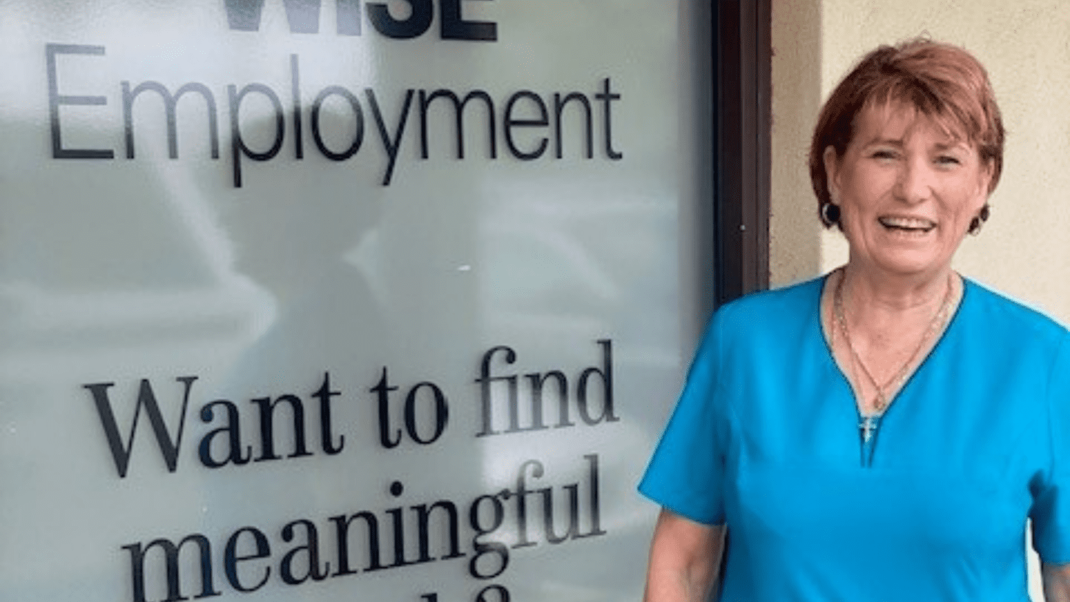 WFA customer Catherine standing in front of WISE office