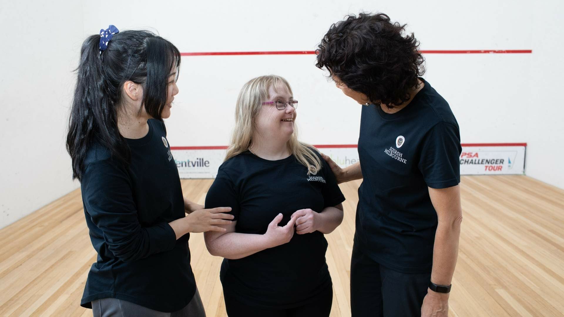 Three women talking to each other.