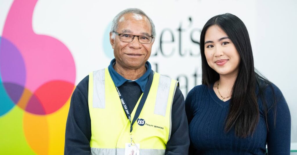 A middle-aged man and a young woman posing in an employment office.