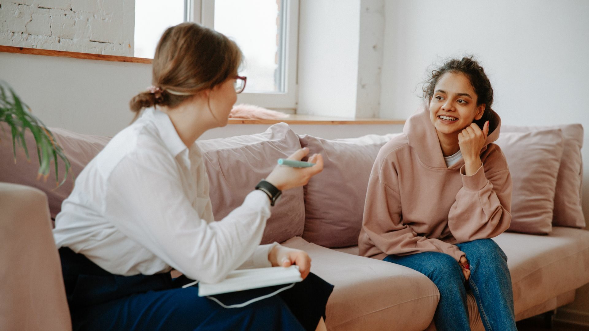 Female counselor providing guidance to a younger woman.