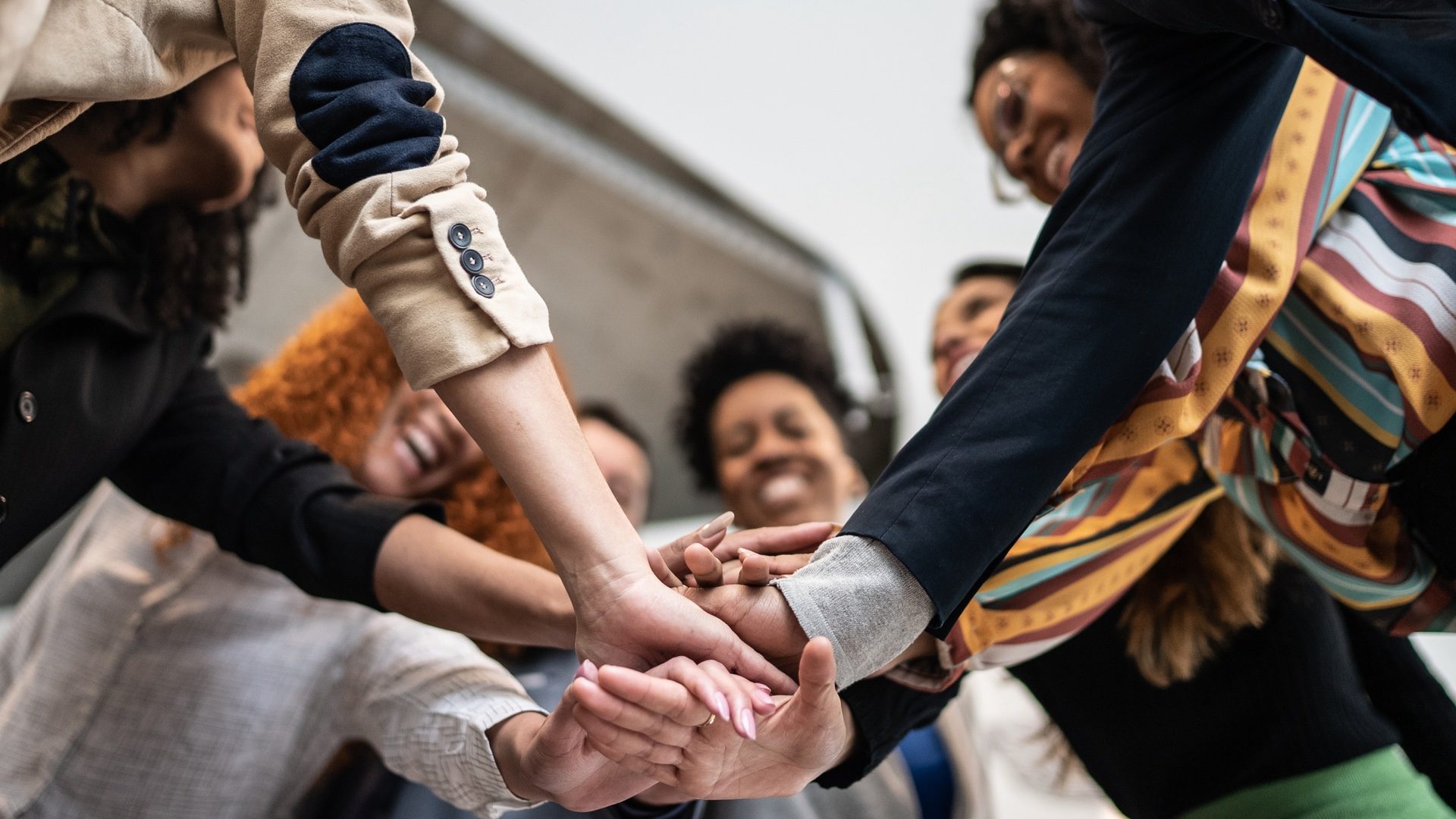 Coworkers with stacked hands at the office.