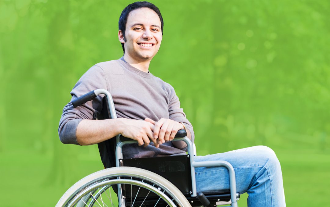 A smiling man on a wheelchair