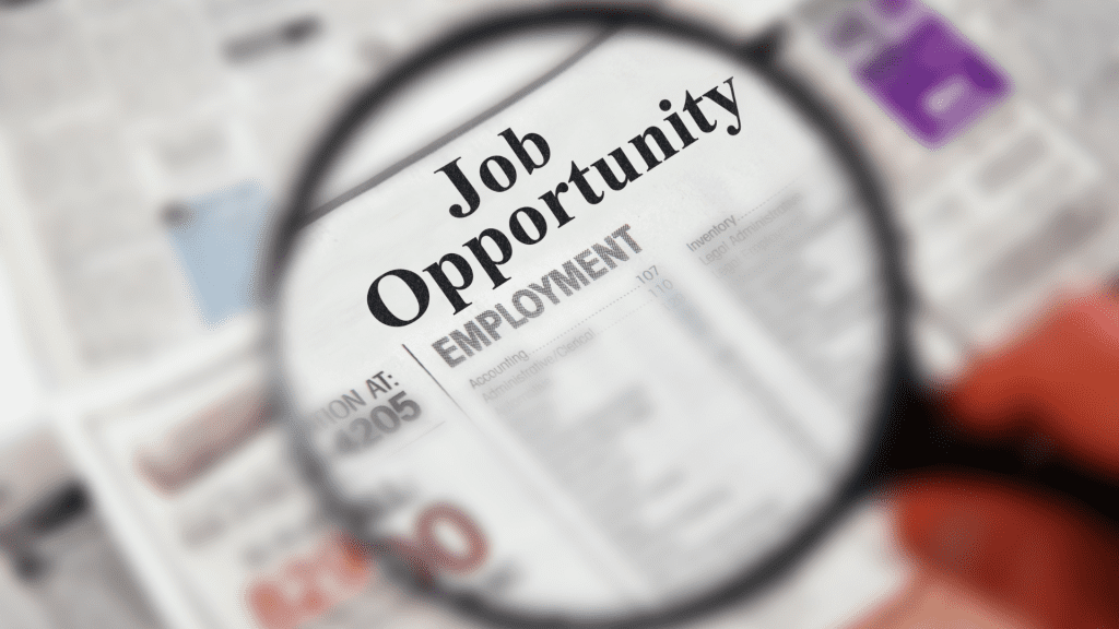 Magnifying glass focused on the words Job Opportunity Employment