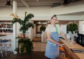 Male waiter bussing glasses.